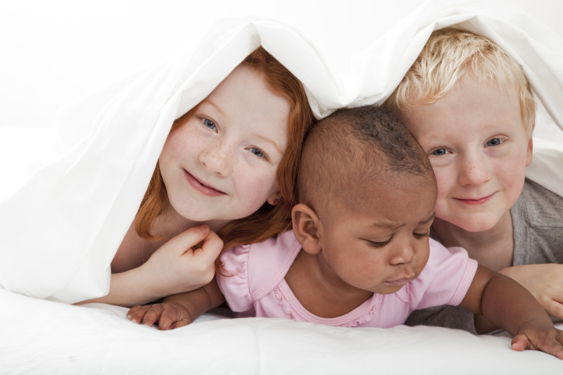young children playing under the covers